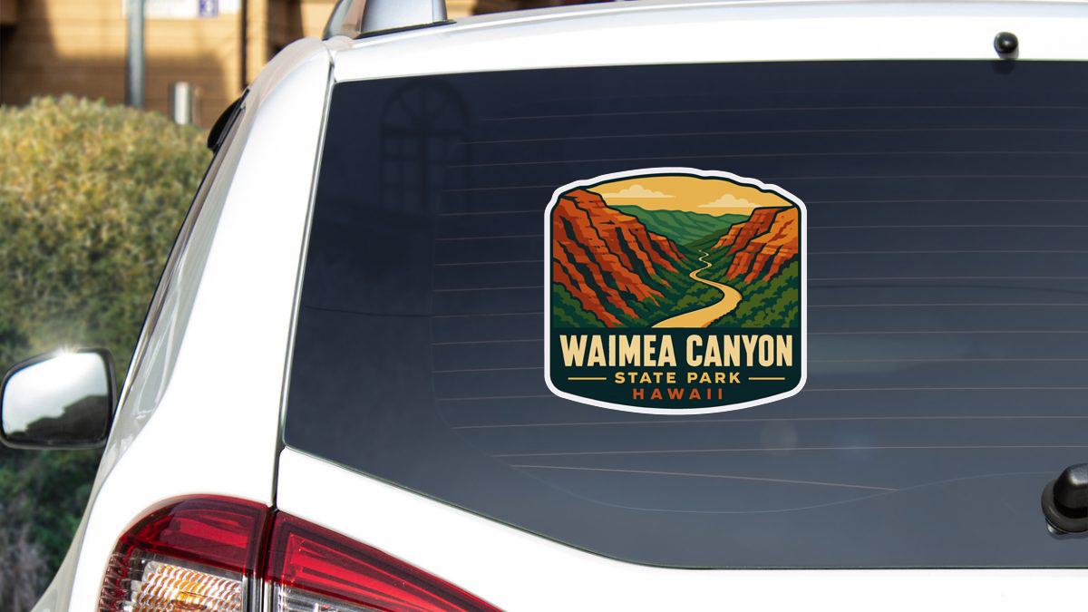 A sticker on the rear window of a car that says "Waihee Canyon State Park, Hawaii".