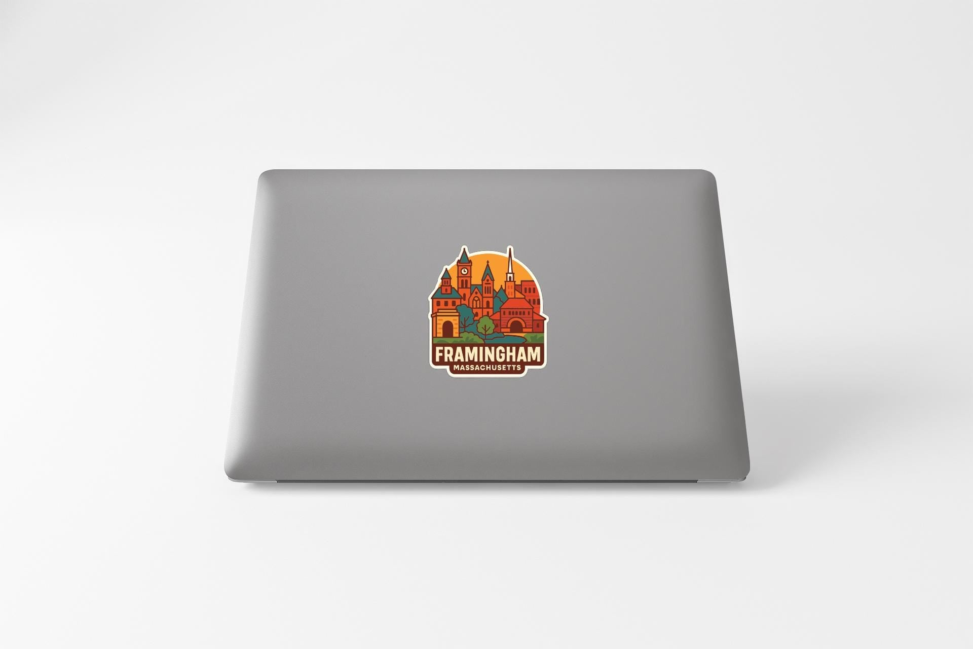 a sticker with a castle and the text "FRAMINGHAM" on the back of a laptop.