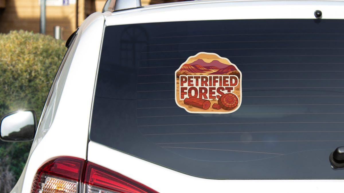 the rear window of a white car with a sticker on it.