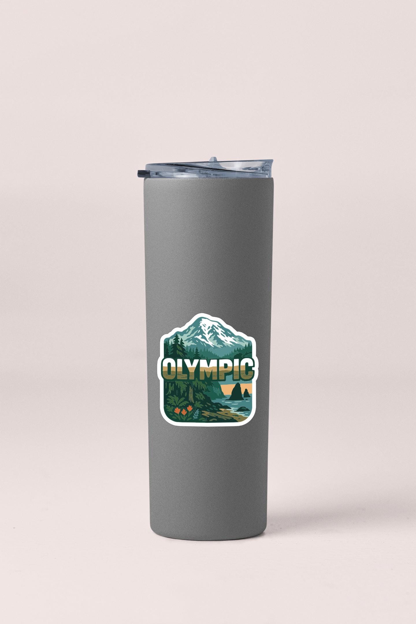 A gray insulated tumbler with a sticker featuring a mountain landscape and the word "Olympic" printed on it.
