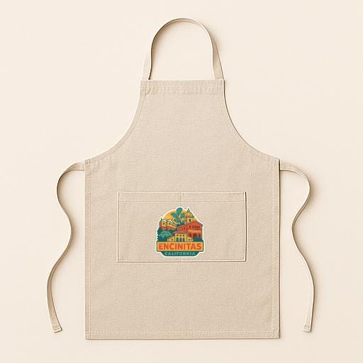 A beige apricot with a colorful graphic of a building and the text "ENCINITAS" printed on it.