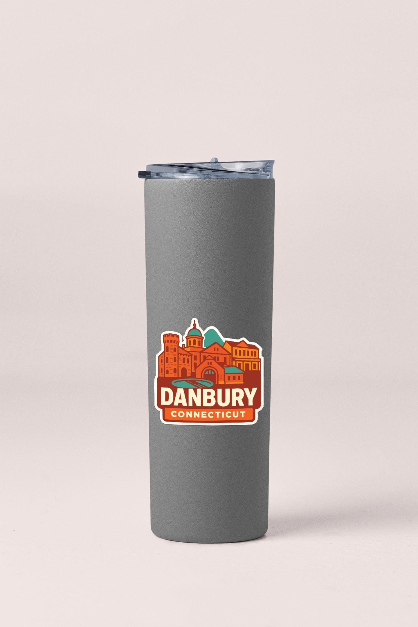 A gray insulated tumbler with a sticker featuring the image of a city skyline and the text "DANBURY CONNECTICUT".