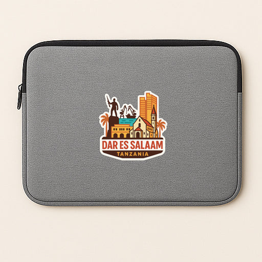 a gray laptop sleeve with a colorful sticker depicting a city skyline and the text "DAR ES SALAAM TANZANIA".