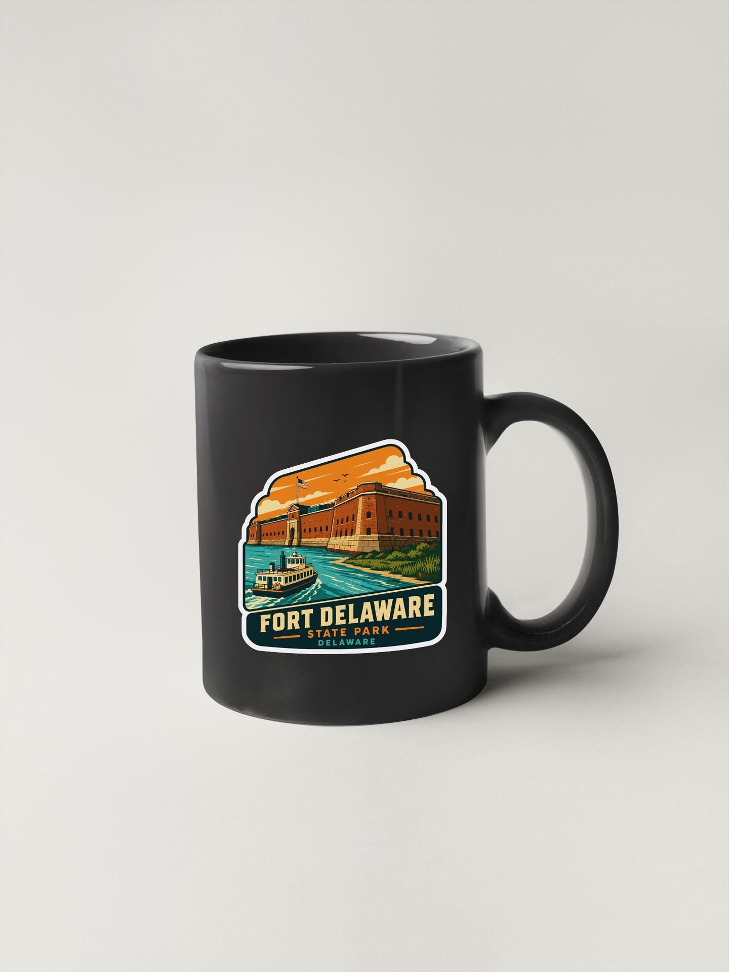 A black coffee mug with a printed design depicting Fort Delaware, a historic fort located in Delaware, USA.
