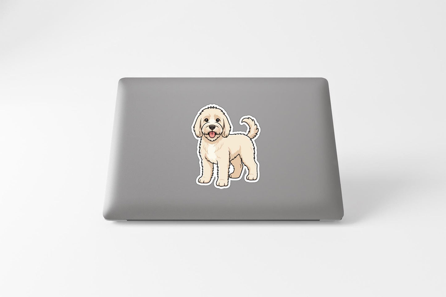 A sticker of a cartoon dog on the back of a laptop computer.
