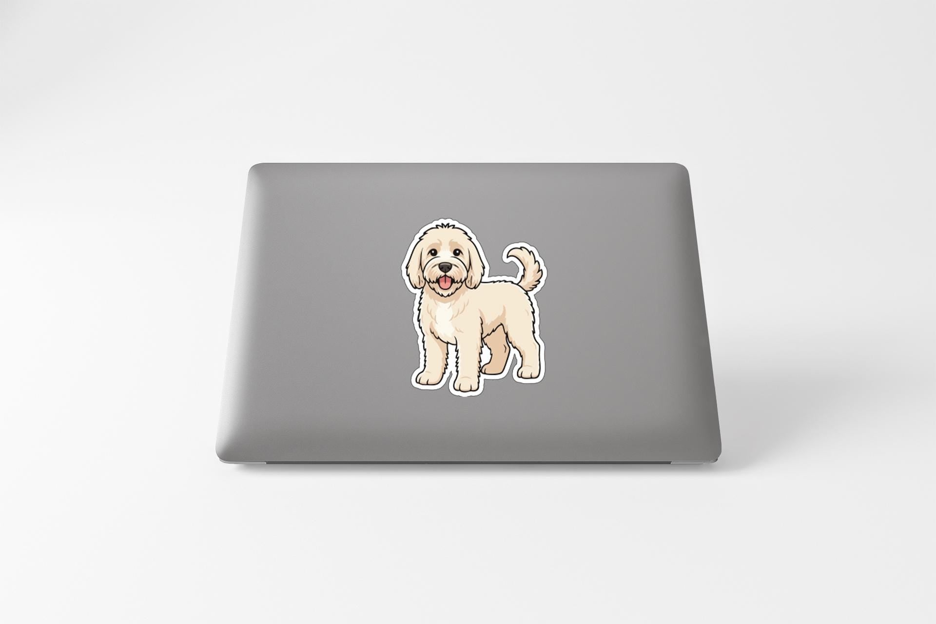 A sticker of a cartoon dog on the back of a laptop computer.