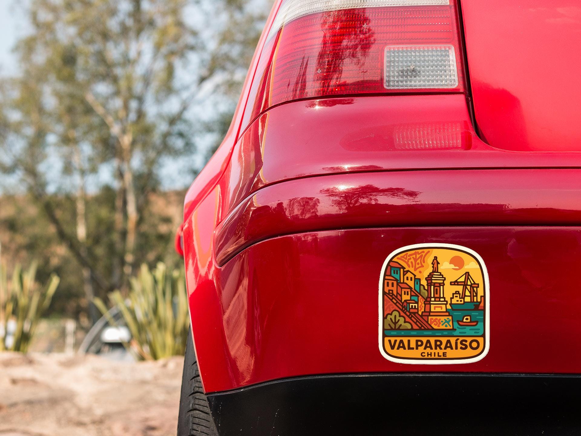 the rear end of a red car with a sticker on the back window that says "VALPARAISO CHILE".