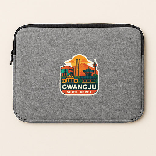 A gray laptop sleeve with a sticker depicting the skyline of Gwangju, South Korea.