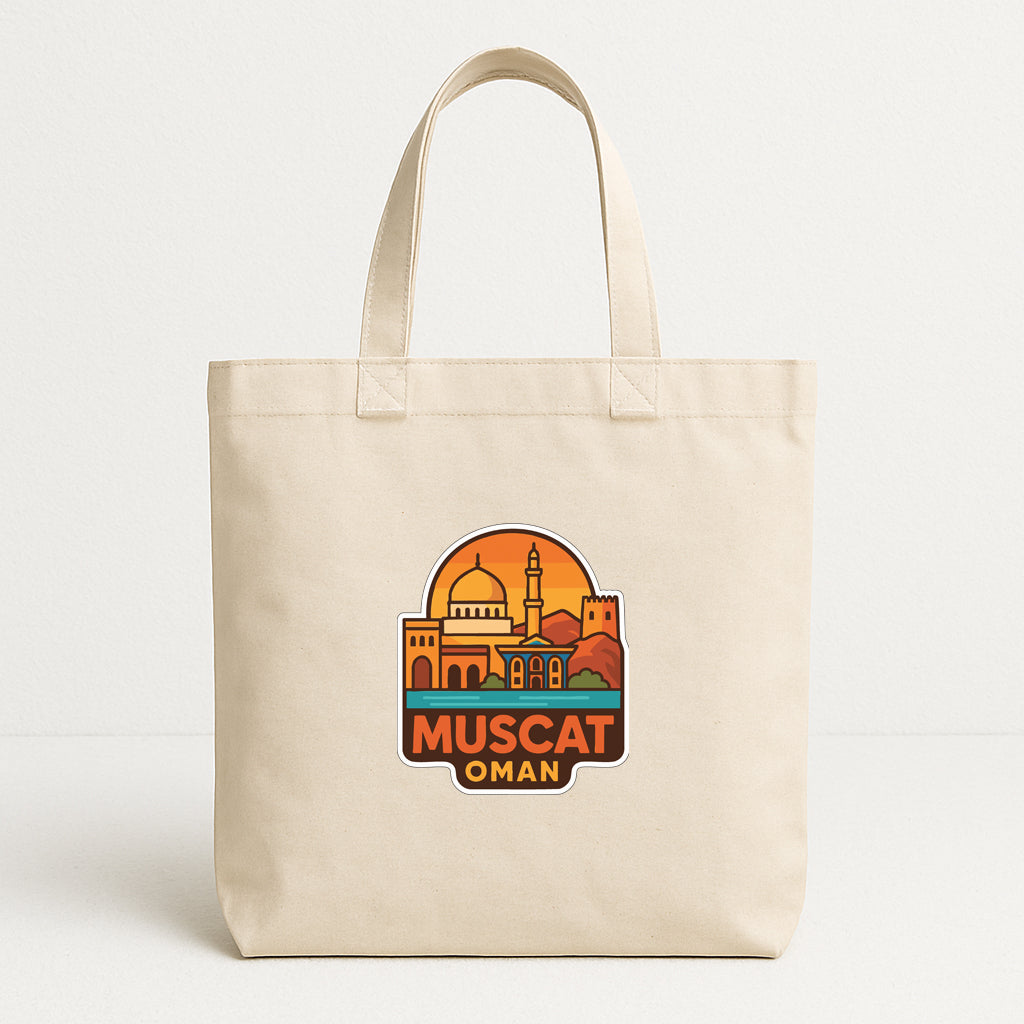A beige tote bag with a graphic design featuring a city skyline and the text "MUSCAT OMAN" printed on it.