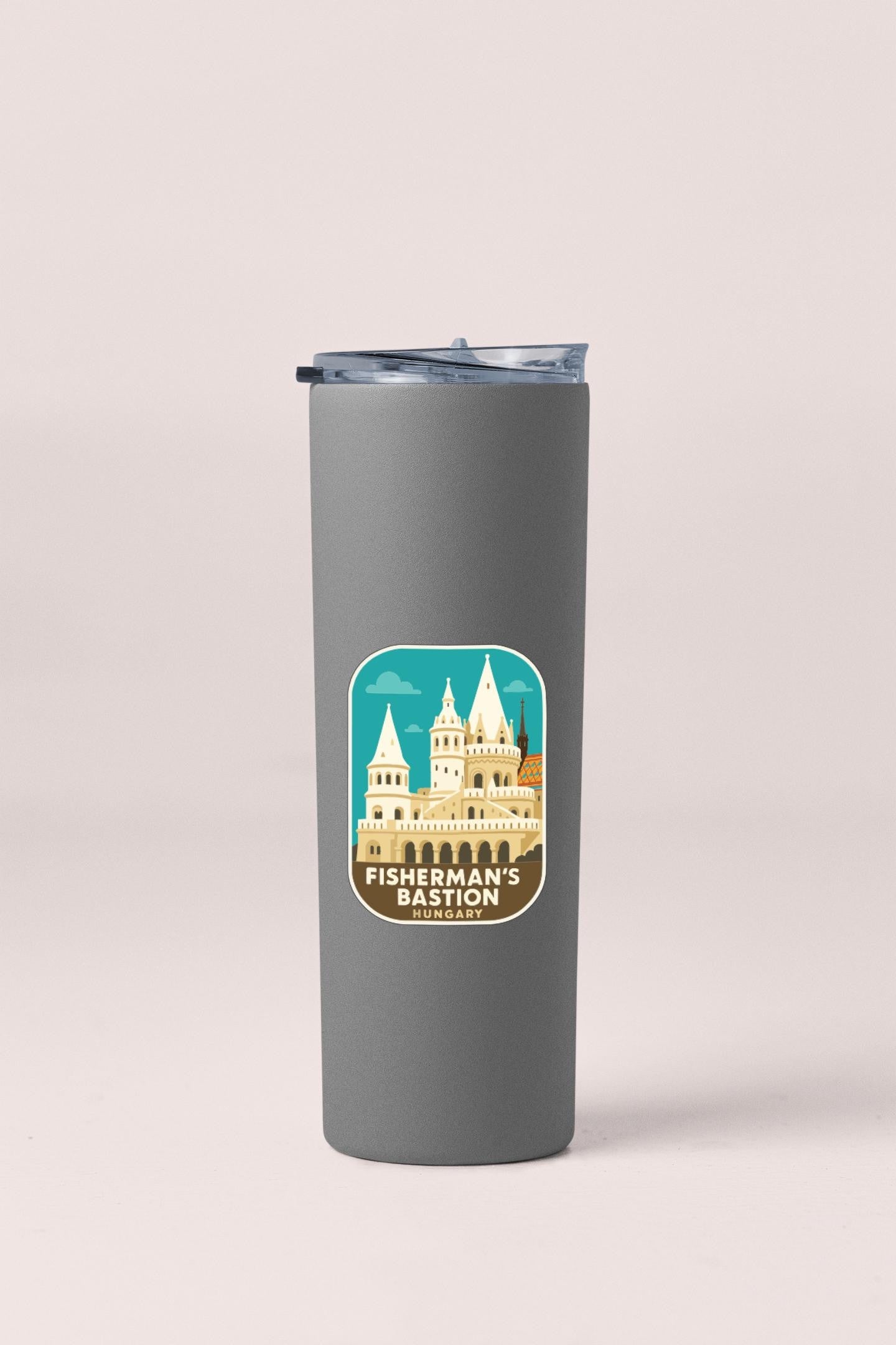 A gray insulated tumbler with a sticker depicting a castle and the text "Fisherman's Bastion" printed on it.