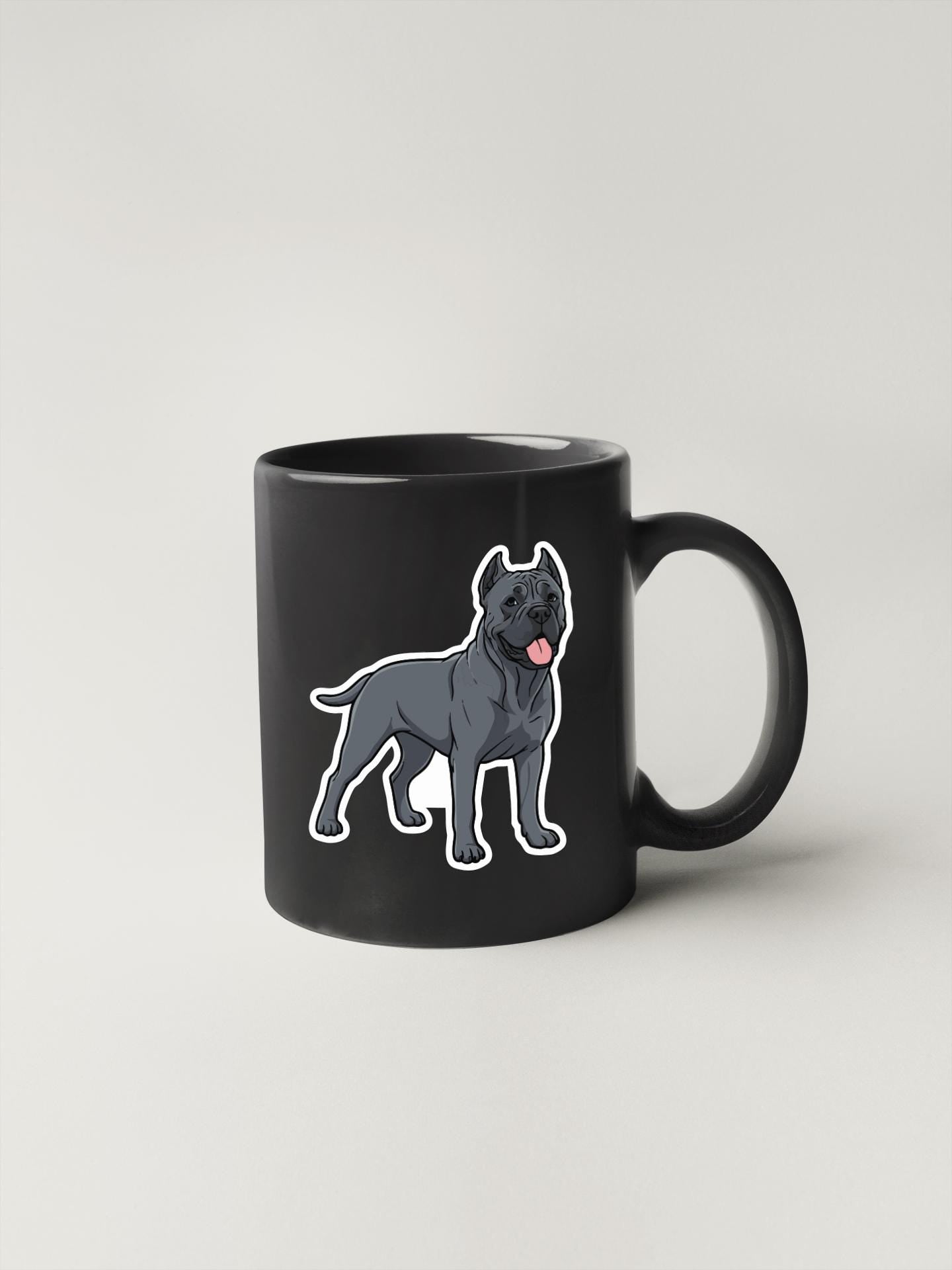 A black coffee mug with a cartoon illustration of a dog on it.