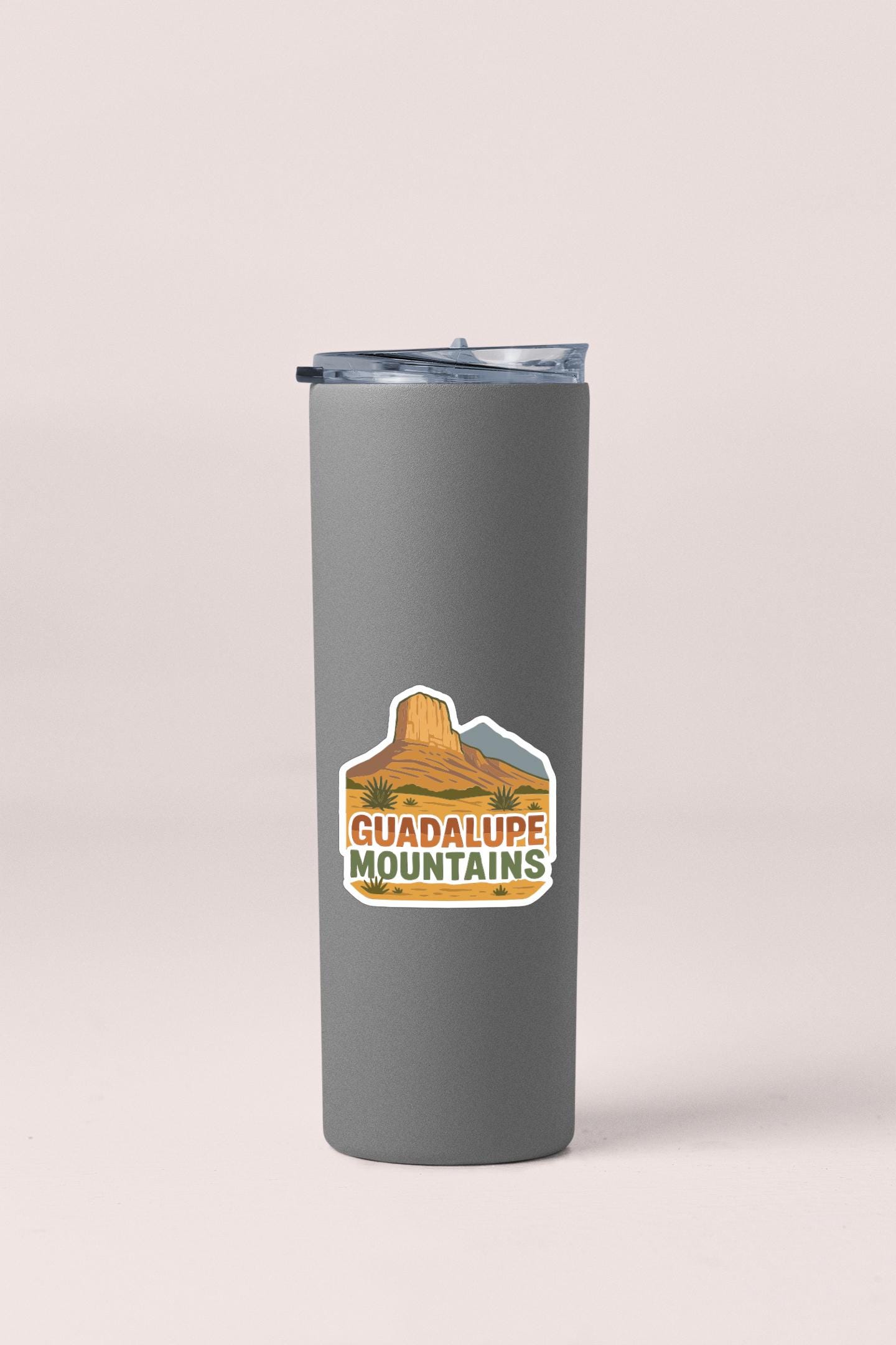 A gray insulated tumbler with a sticker that says "GUADALUPE MOUNTAINS".