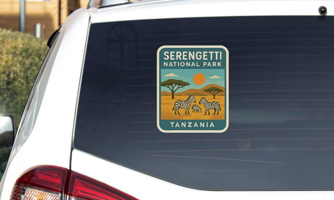 A sticker on the rear window of a car that says "Serengeti National Park Tanzania".