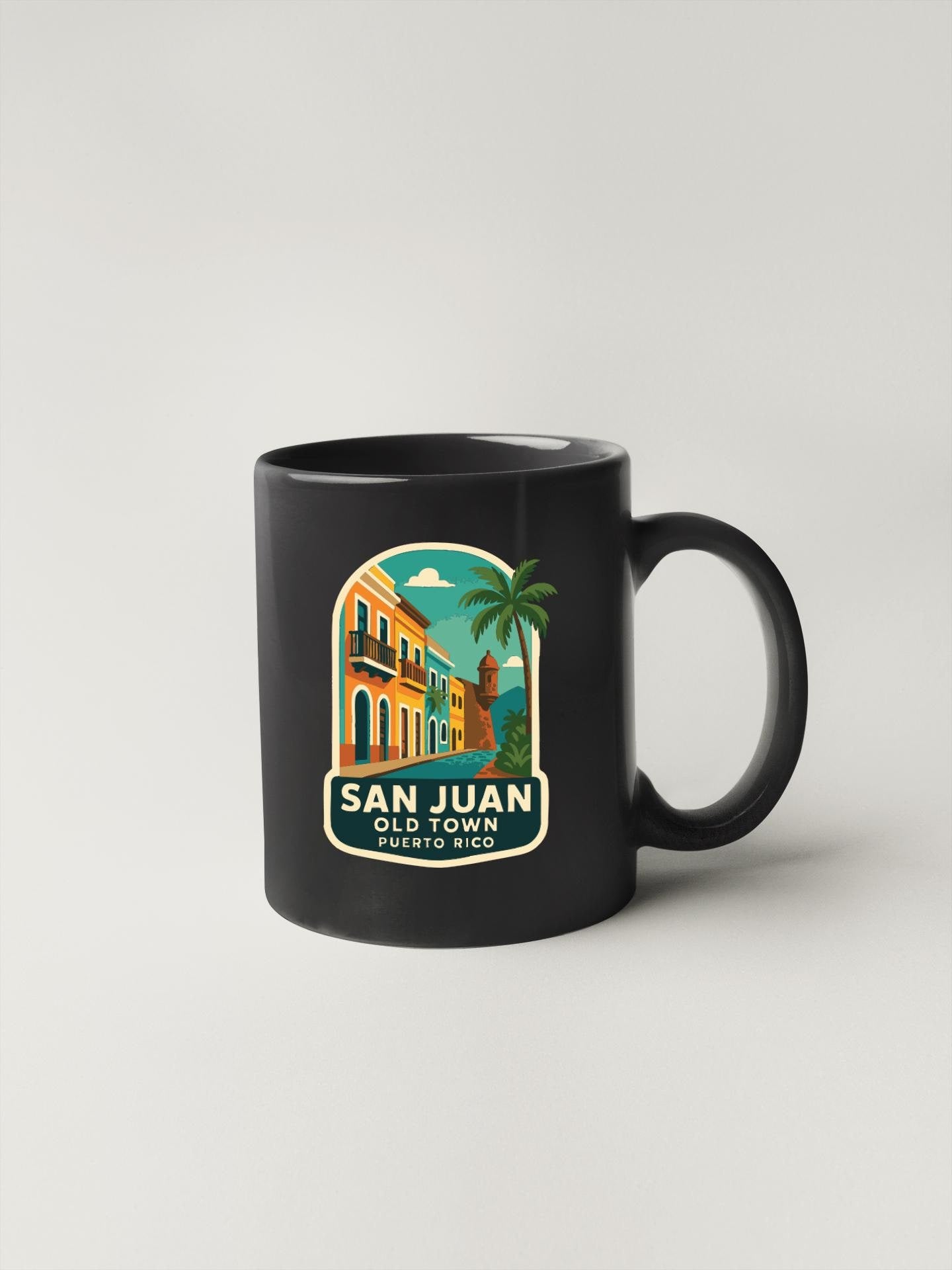 A black coffee mug with a colorful illustration of a tropical town and the text "SAN JUAN OLD TOWN PORTUGAL" printed on it.
