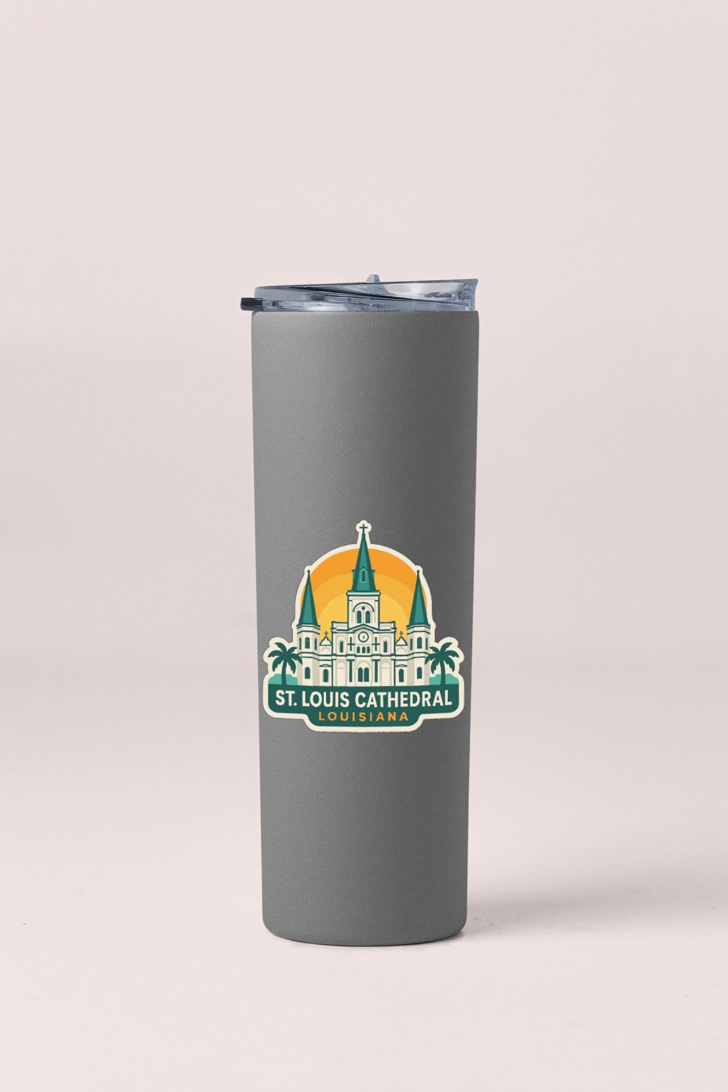 A gray insulated tumbler with a sticker depicting St. Louis Cathedral.