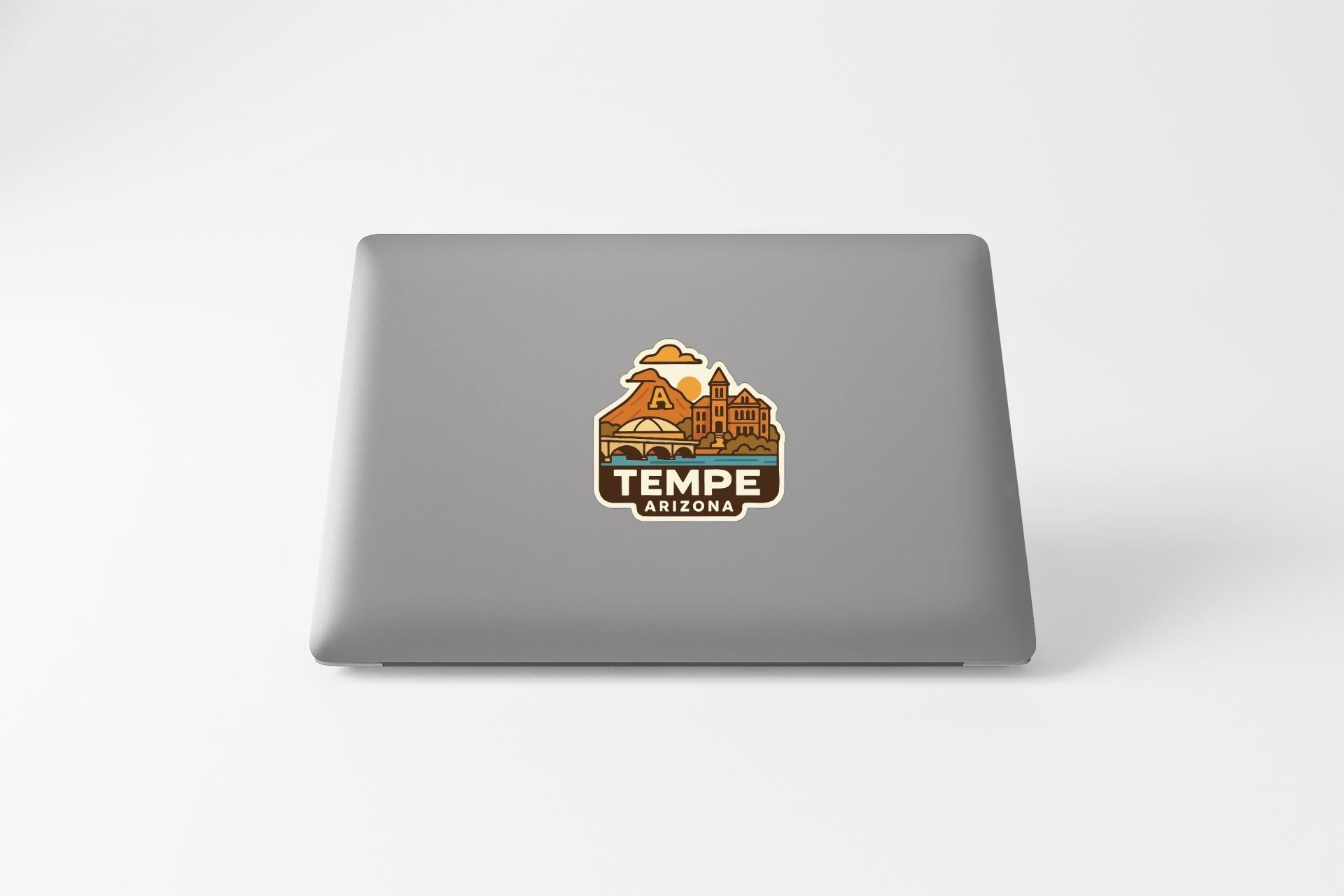 a sticker with a graphic of a building and the text "TEMPE ARIZONA" on the back of a laptop.