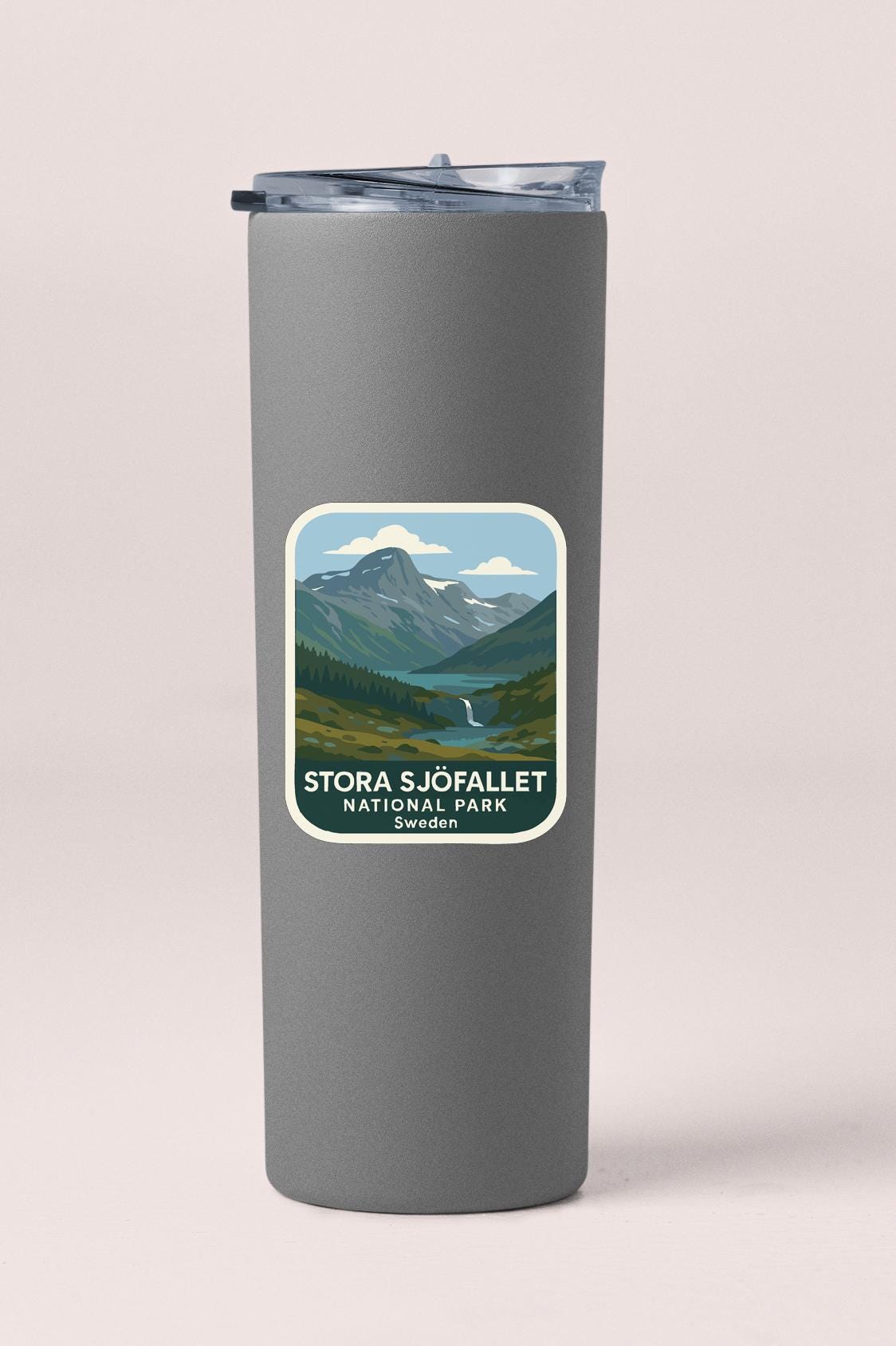 A gray insulated tumbler with a label that features a mountain landscape and the text "STORA S.JÖFALLET NATIONAL PARK SWEDEN".
