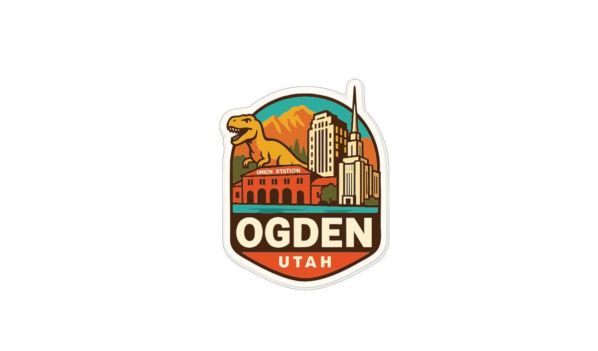A sticker or emblem featuring a dinosaur, buildings, and mountains, with the text "OGDEN UTAH" prominently displayed.