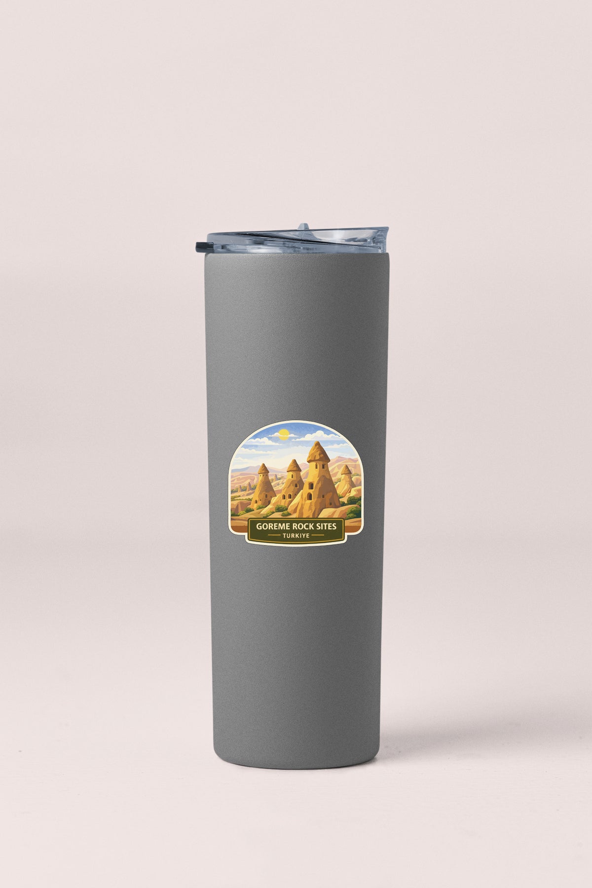 A gray insulated tumbler with a sticker depicting the Canyons of the Grand Canyon.