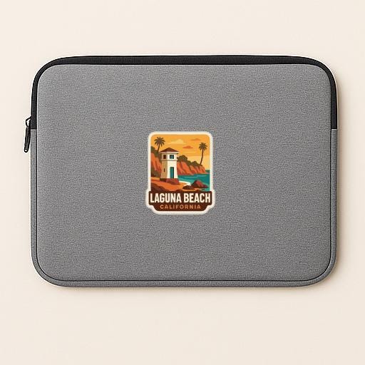 A gray laptop sleeve with a sticker depicting a beach scene and the text "LAGUNA BEACH, CALIFORNIA".