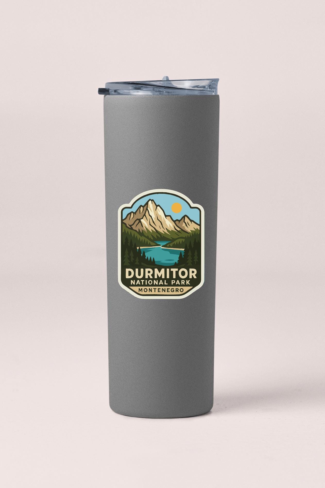 A gray insulated tumbler with a Dermitor National Park logo printed on it.