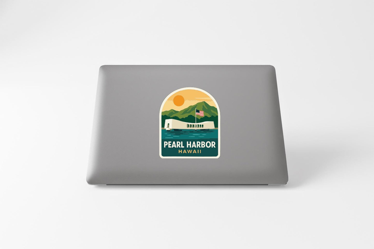 a sticker or decal of Pearl Harbor, Hawaii, on the back of a laptop computer.