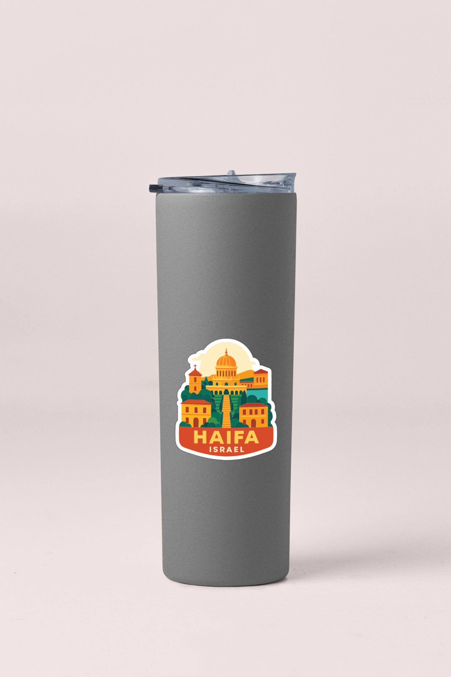 A gray insulated tumbler with a sticker depicting the city of Haifa, Israel.