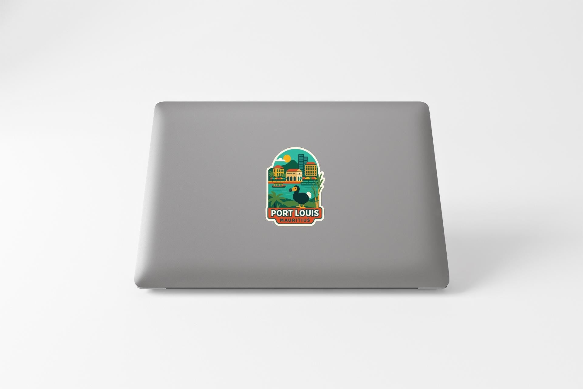 A sticker on the back of a laptop, depicting a cityscape with a large building and a bird.