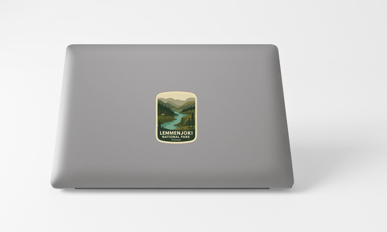 A sticker with a scenic landscape on a laptop.