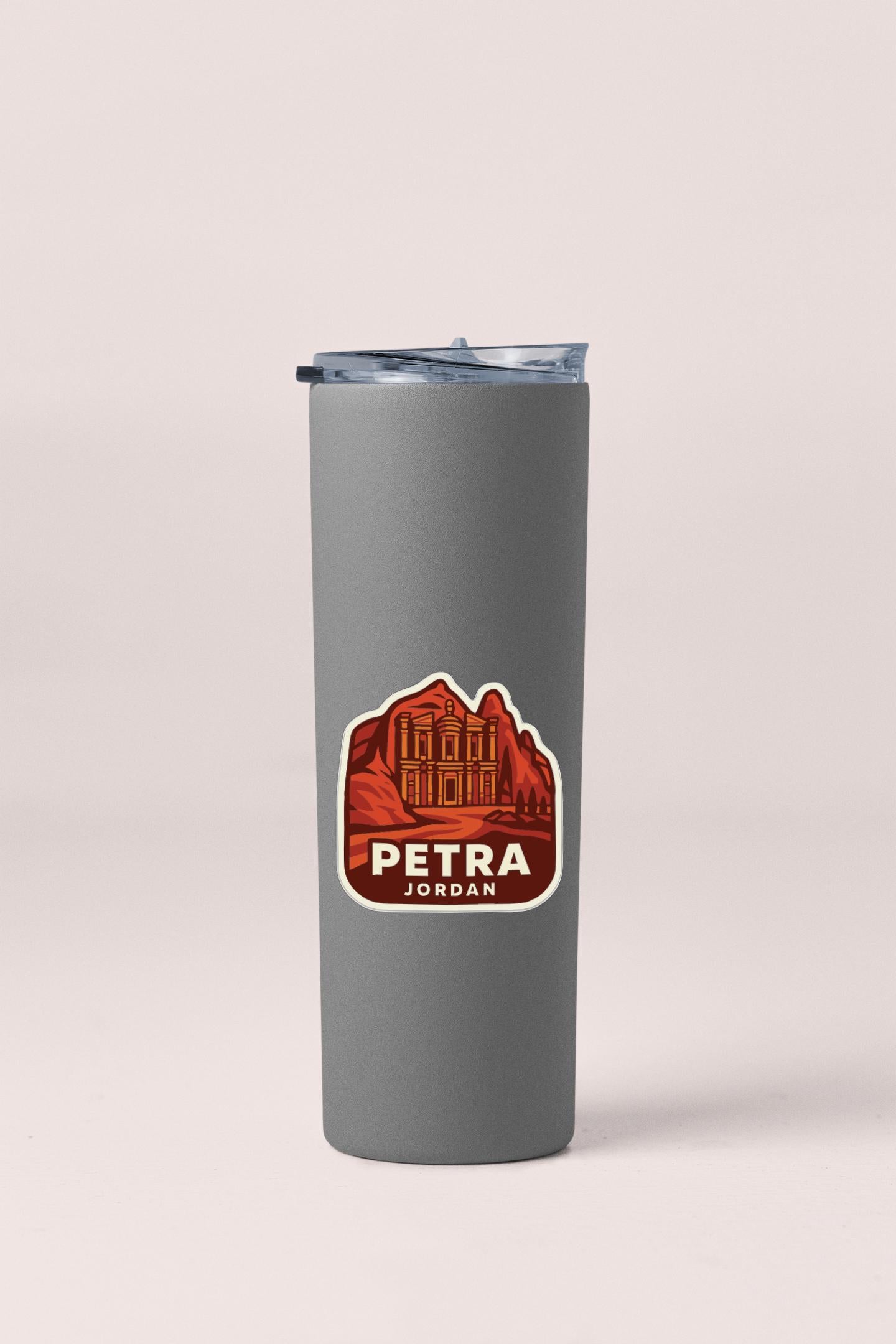 A gray insulated tumbler with a sticker featuring an illustration of a building and the text "PETRA JORDAN" printed on it.
