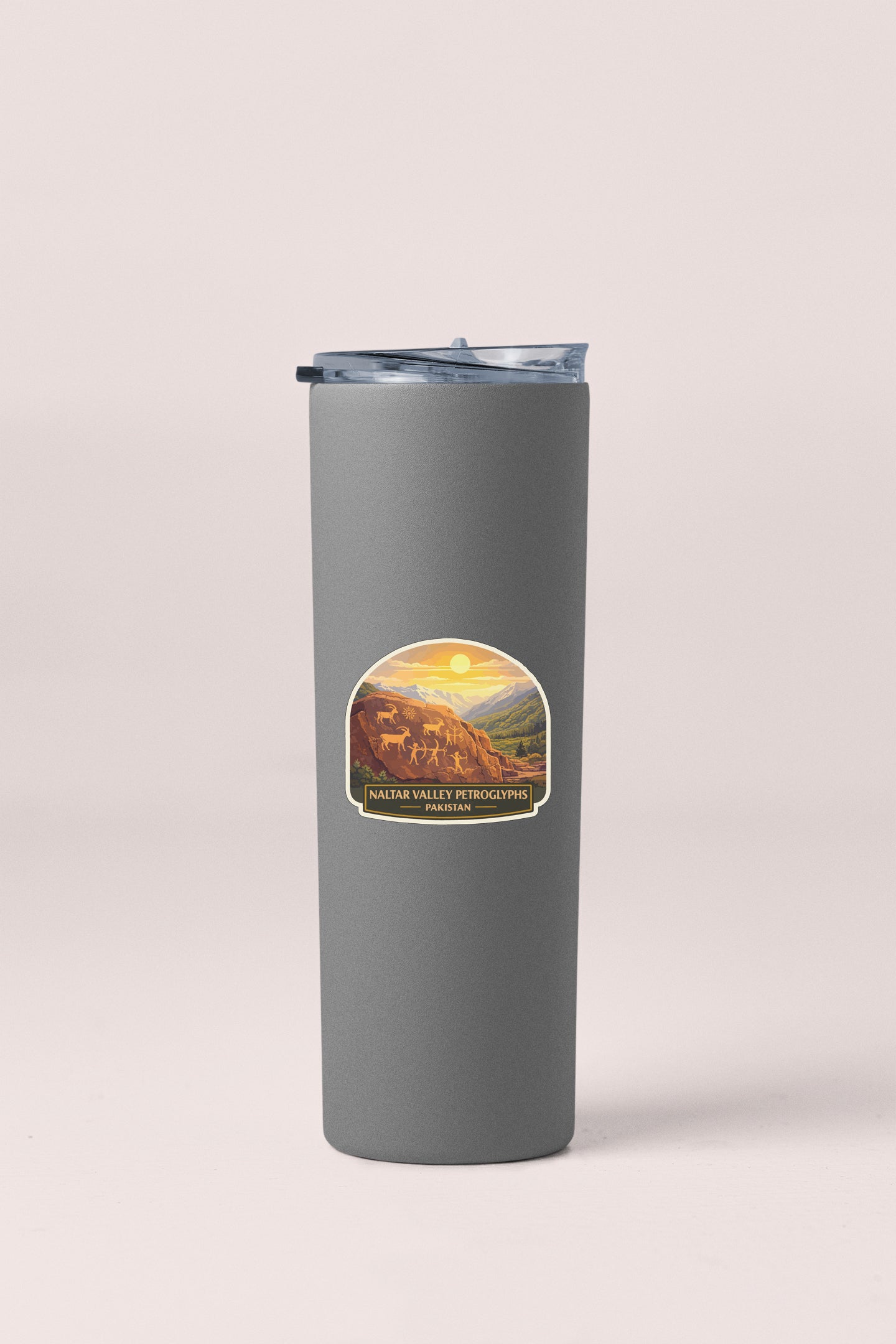 A gray insulated tumbler with a label depicting a scenic landscape.