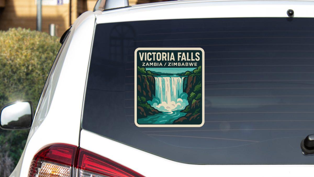 A sticker on the rear window of a car that says "VICTORIA FALLS ZAMBIA / ZIMBABWE".