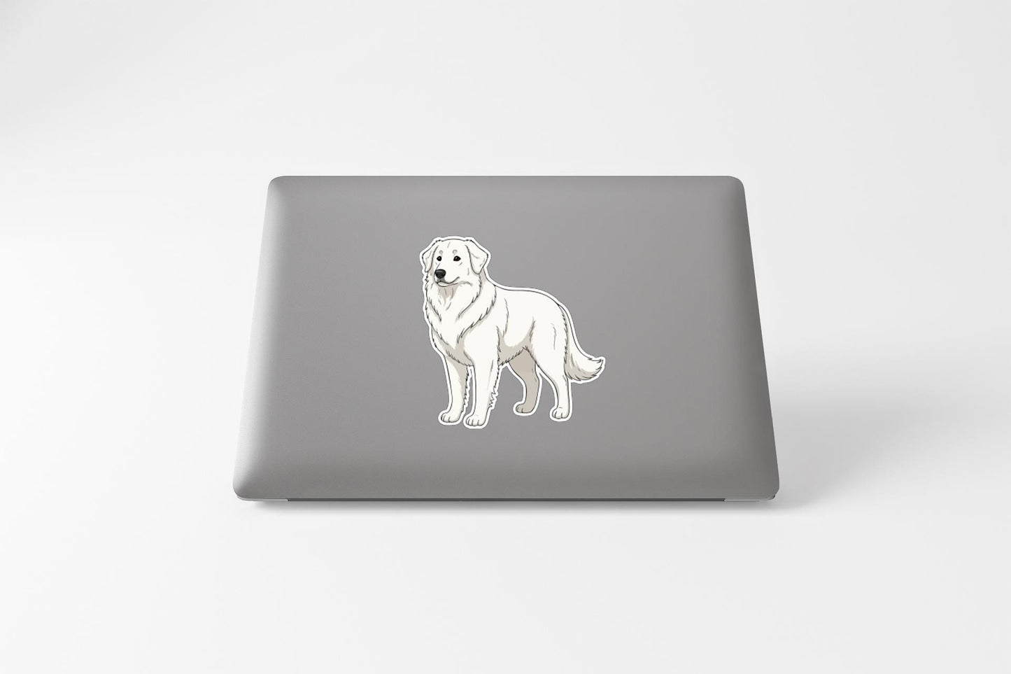 A sticker of a dog is on the back of a laptop.