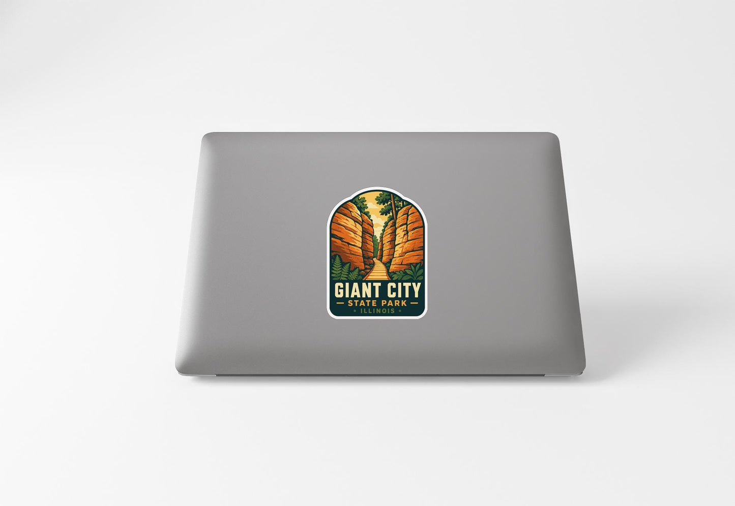 a sticker with a graphic design on the back of a laptop.