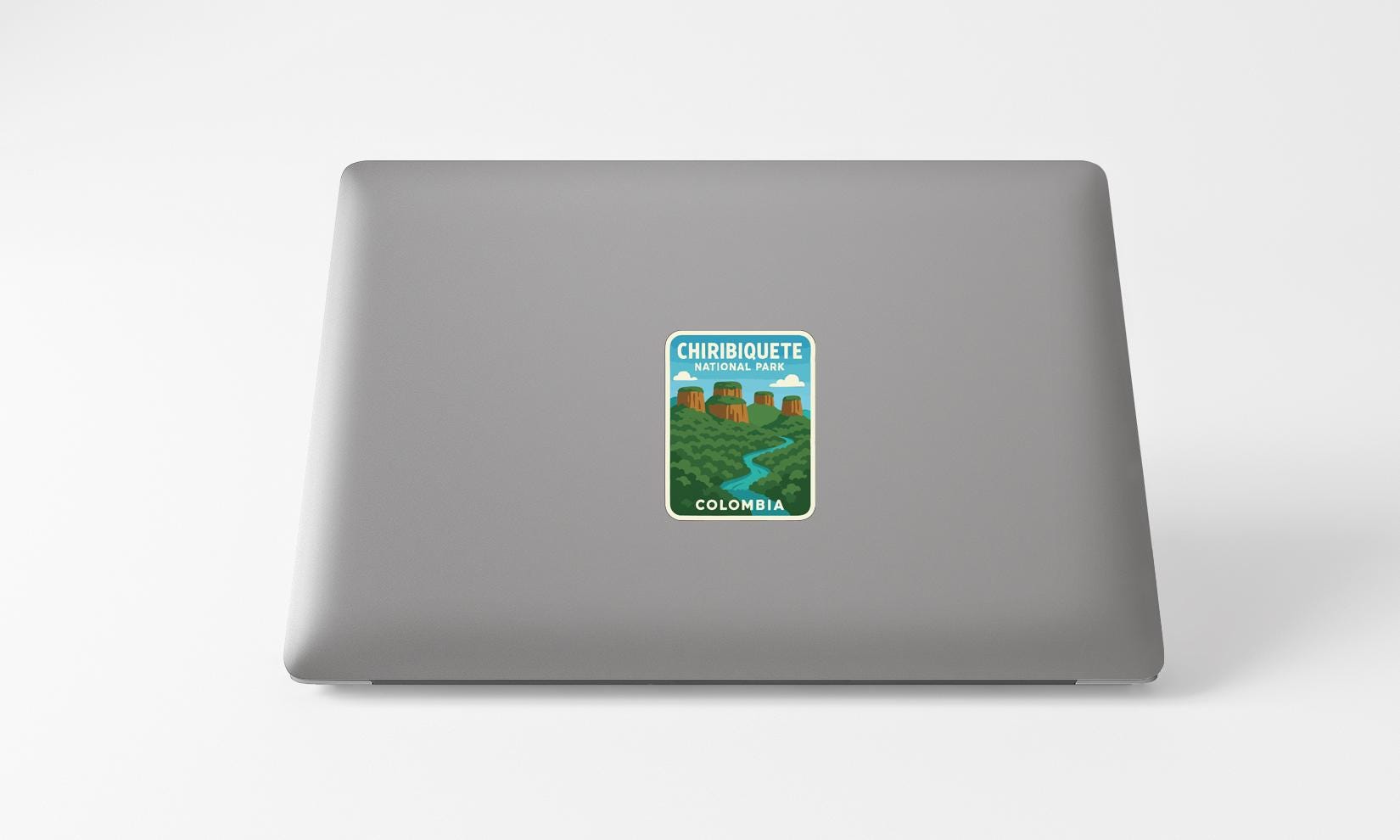 a sticker with a scenic landscape of mountains and a river on the back of a laptop.