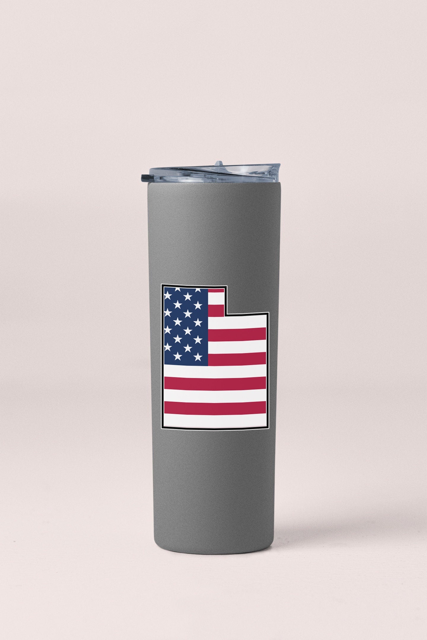 a gray tumbler cup with a flag on it
