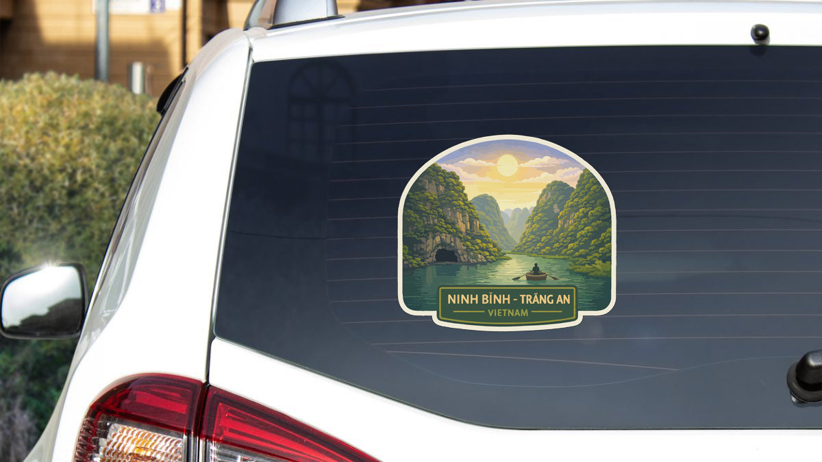 A sticker on the rear window of a white car, depicting a scenic landscape with mountains, a river, and a boat.