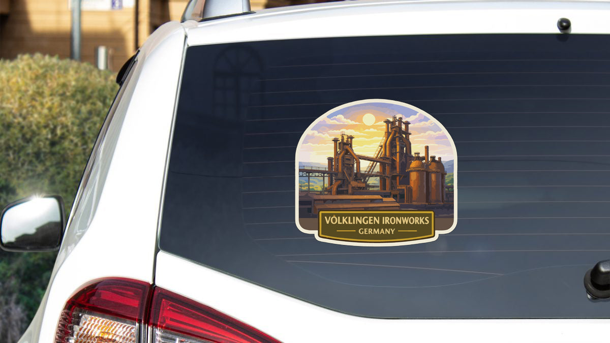 a sticker on the rear window of a white car, depicting a scenic industrial landscape with a bridge and buildings.