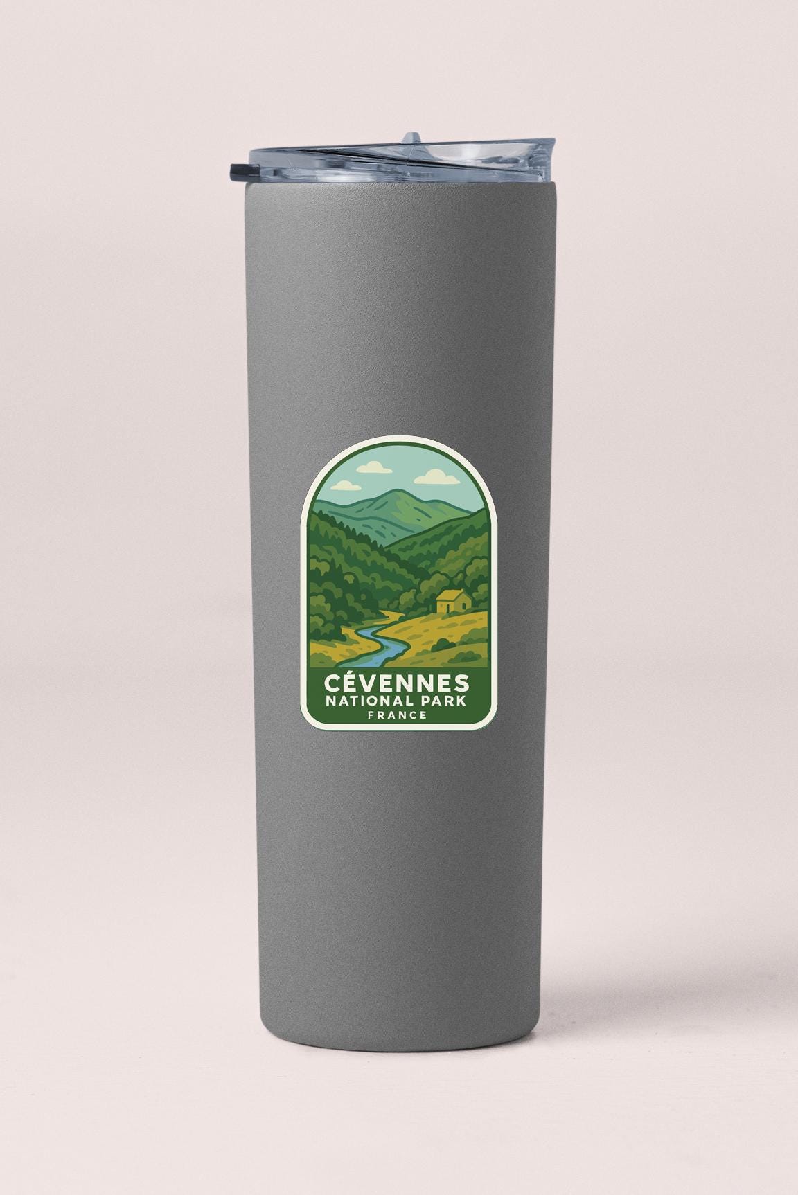 A gray cylindrical container with a label that features an illustration of a mountain landscape and the text "Cevennes National Park, France".