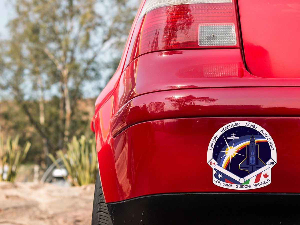 a close up of a red car with a sticker on it