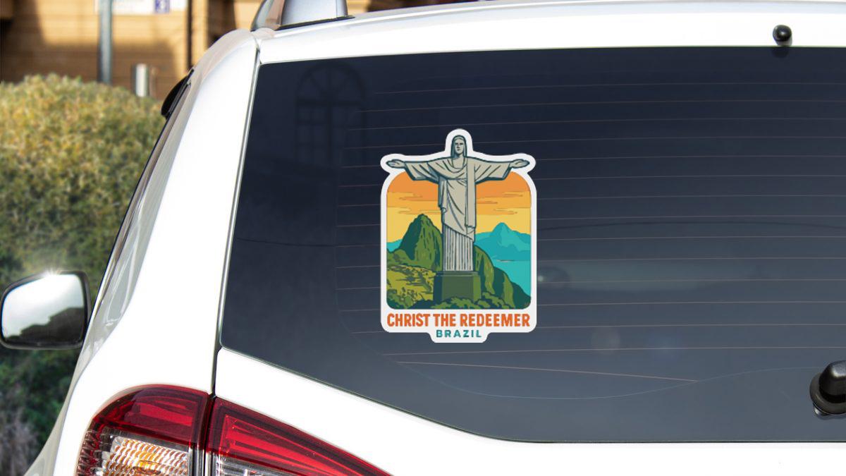 A sticker on the rear window of a car depicting the Christ the Redeemer statue in Brazil.