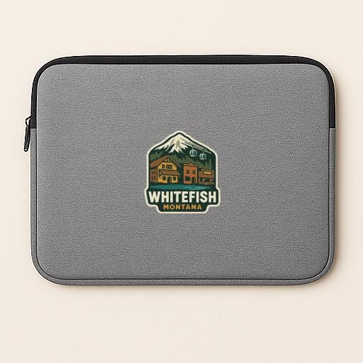 A gray laptop sleeve with a logo of Whitefish Montana on it.