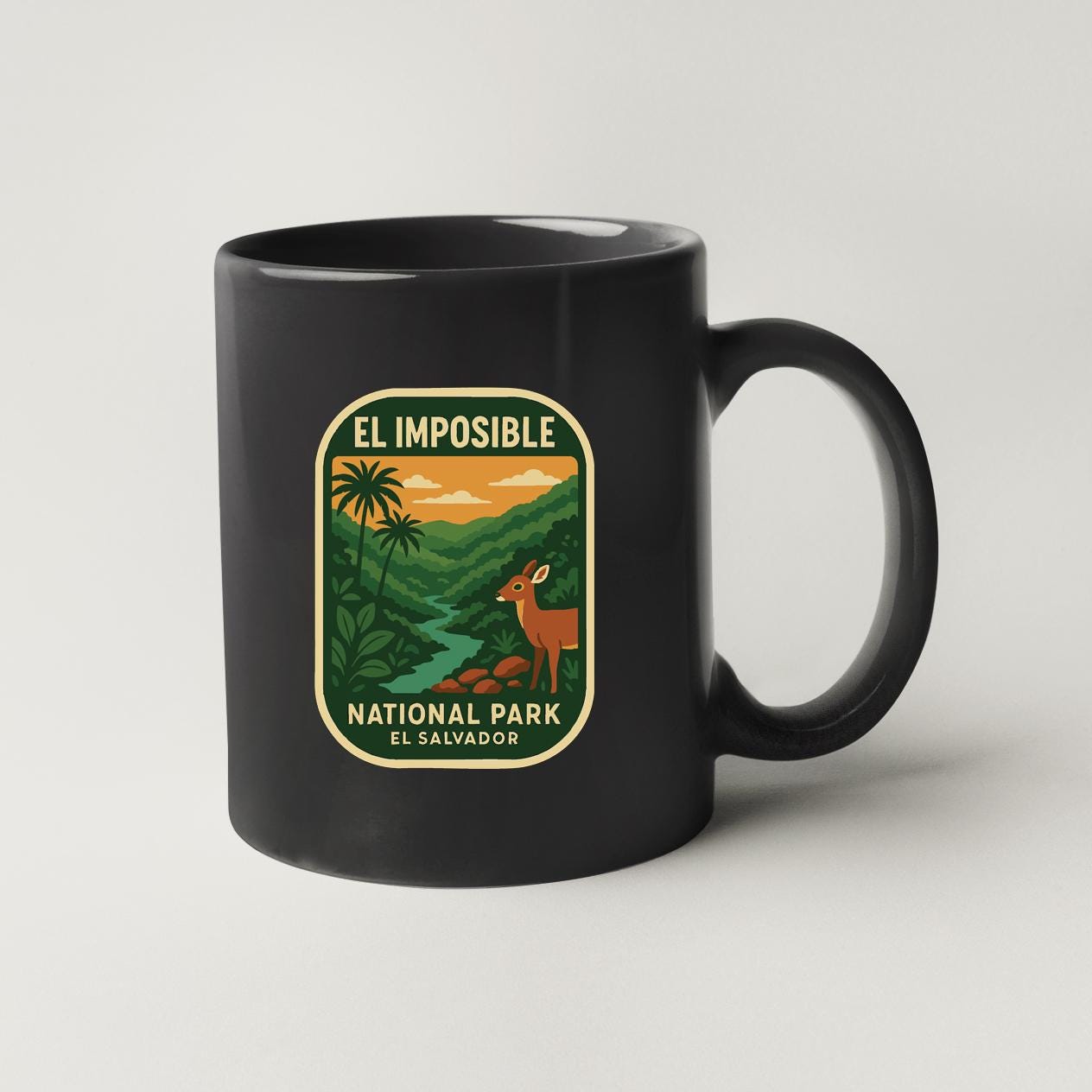 A black coffee mug with a label that says "EL IMPOSIBLE NATIONAL PARK EL SALVADOR".