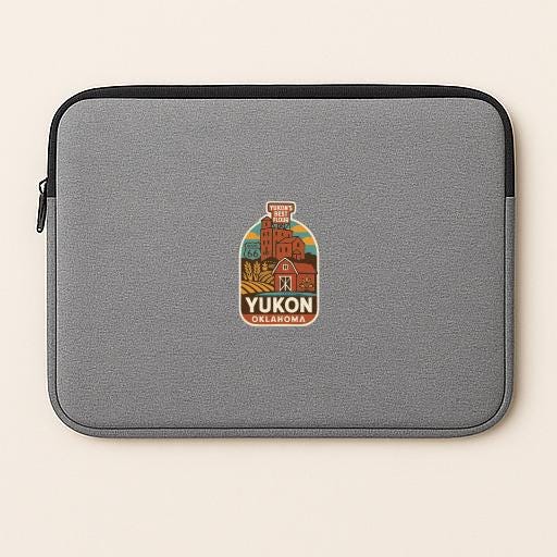 a gray laptop sleeve with a colorful sticker on it, depicting a scenic view of Yukon, Oklahoma.