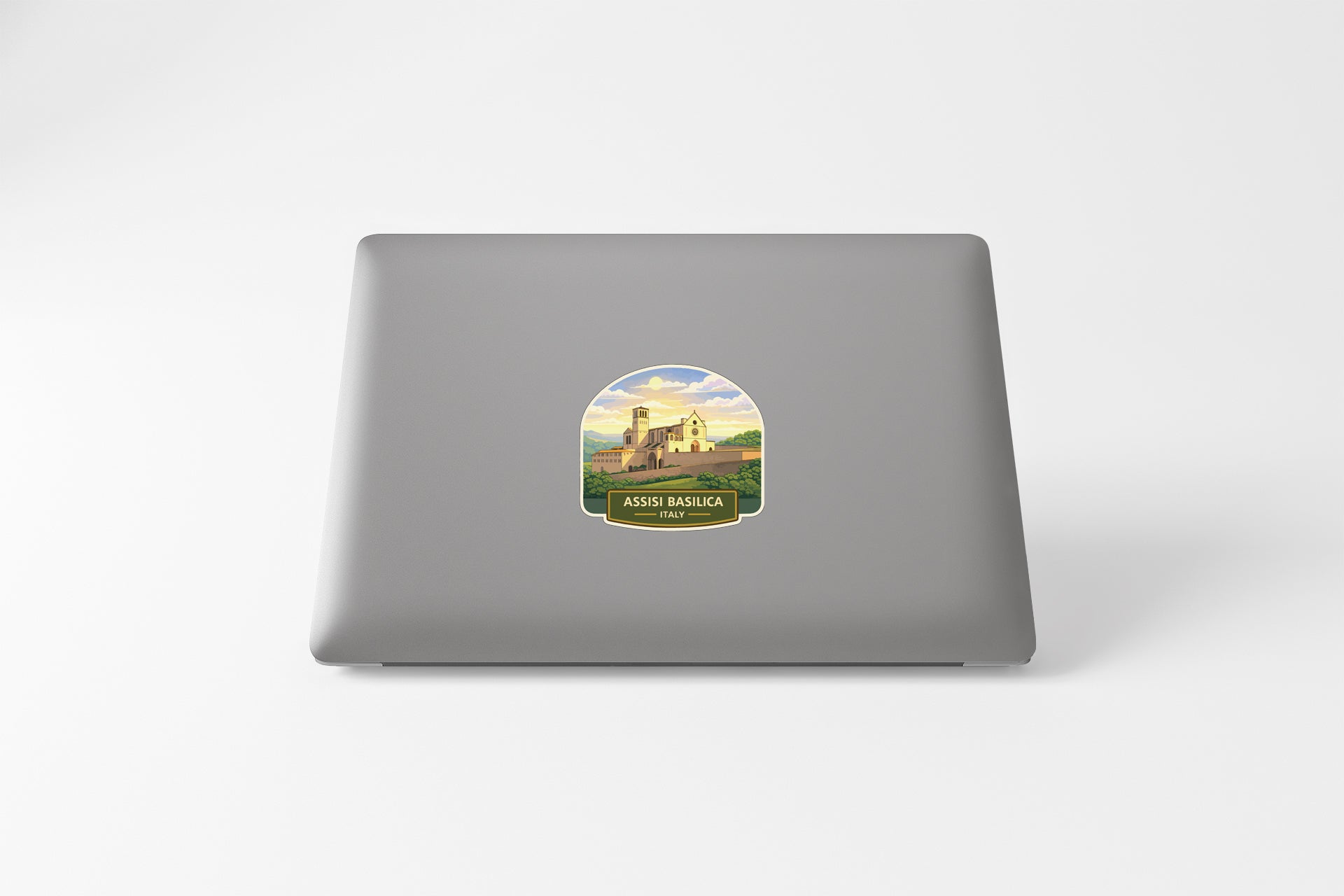 a sticker with a castle on it, placed on the back of a laptop.