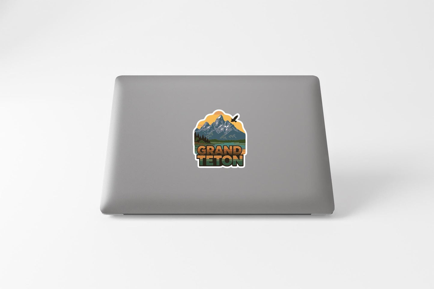 A sticker on the back of a laptop that says "GRAND Teton".