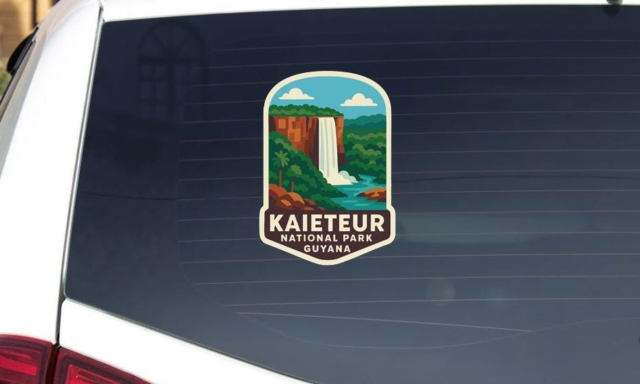 A sticker on the rear window of a car that says "Kaieteur National Park Guyanana".