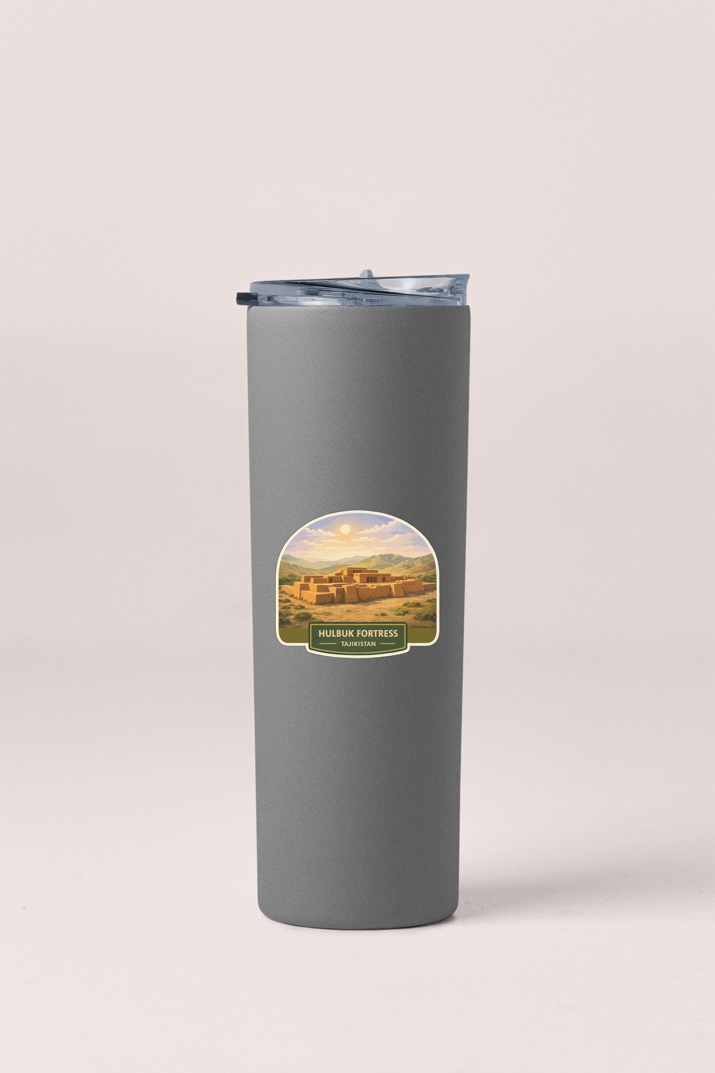 A gray insulated tumbler with a label depicting a scenic landscape.