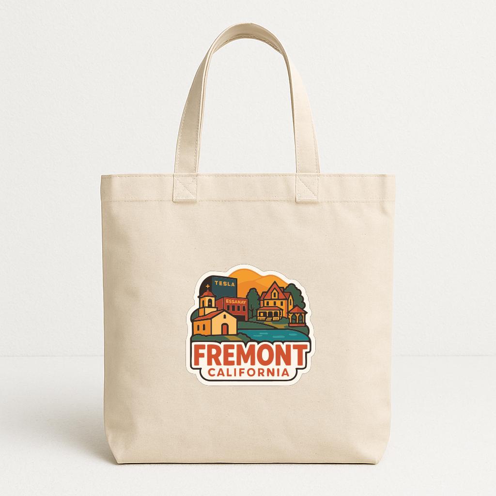 A beige tote bag with a printed design of a cityscape and the text "FREMONT CALIFORNIA" printed on it.