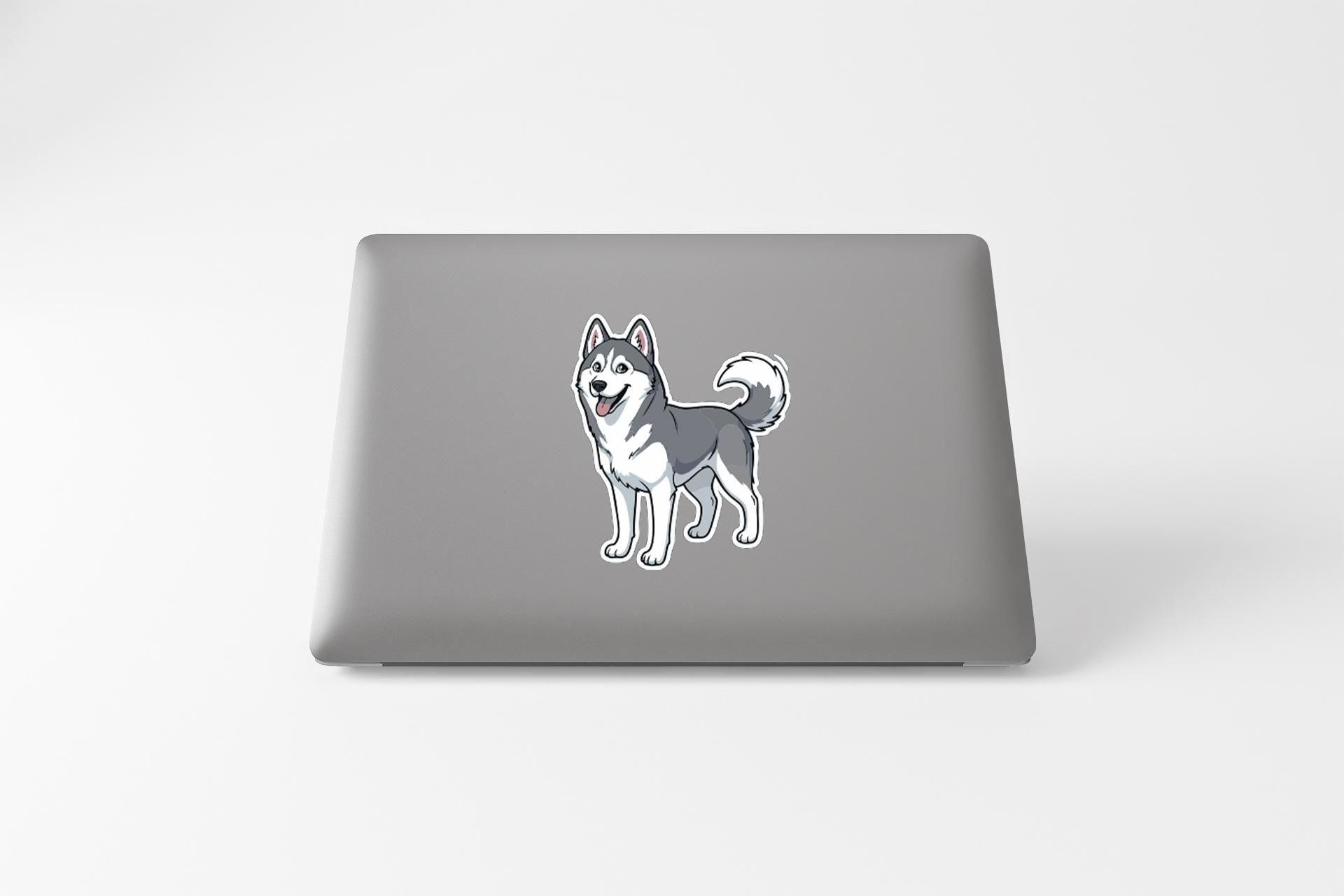 A sticker of a husky dog is on the back of a laptop.